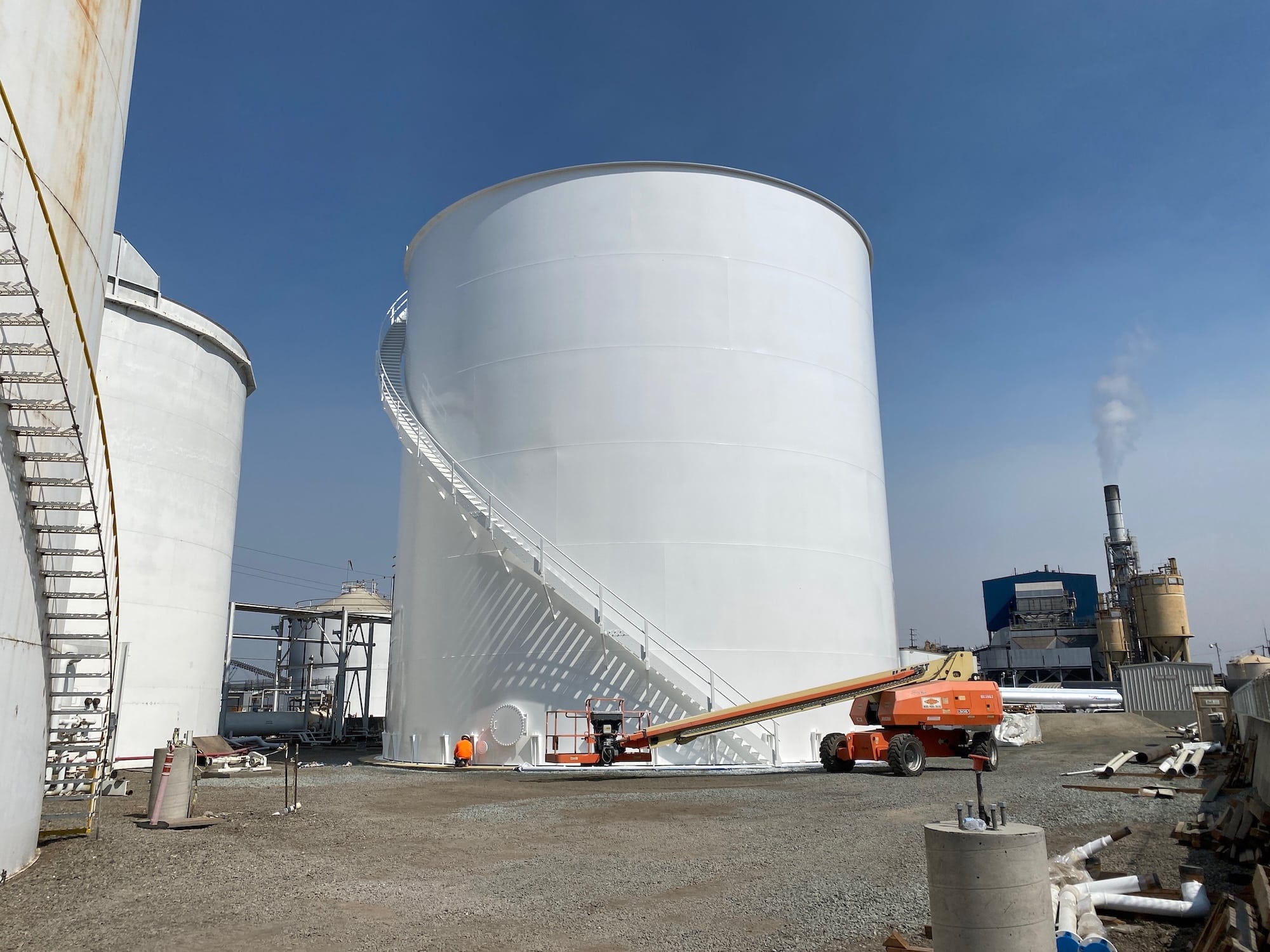 Large white fuel storage tank with ladder
