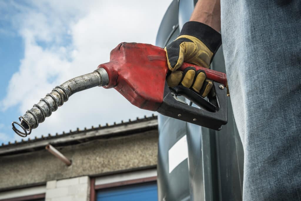 Men Hold Diesel Pump Nozzle in His Hand