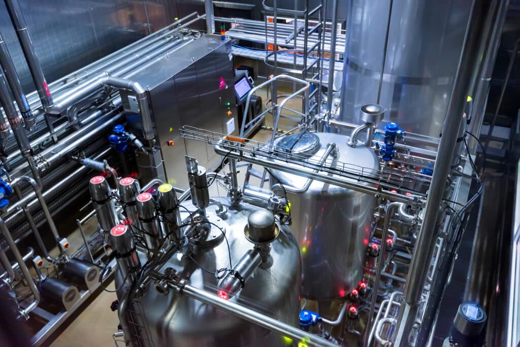 Tanks mixing chemicals together at a soft drink factory